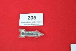 German Tinplate Road Sign Badge – arrow-shaped badge inscribed “Einbahnstraße” (One Way Street),