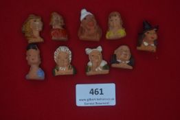 Collection of nine German WWII terracotta caricature badges — Named busts including “Adele”, “