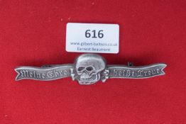 SS Cap Skull and Motto Bar – An SS cap badge combining a prominent Totenkopf skull motif with a