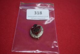 25-Year Service Badge – A small enamel and silvered badge in shield form, bordered by a silver oak-