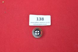 A German political party membership badge, small circular bronze and enamel type with black cross on