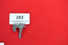 Cast Metal Commemorative Tinnie Badge in the form of a Battle Axe – A grey-metal badge depicting a