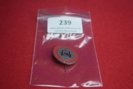 Metal Stickpin Badge with Motoring Symbol – A small circular badge with a red border and central