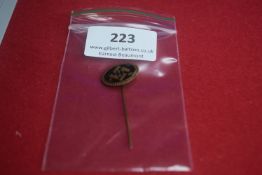 Enamel stickpin with black and blue enamel, featuring the intertwined letters 