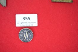 SS Donation Badge – A circular pressed metal badge with black enamel field, central SS runes, and