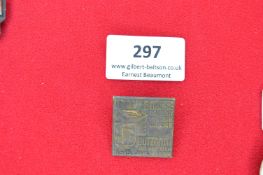 Square Metal Commemorative Badge “Braune Messe Butzbach 1934” – A pressed brass badge with raised