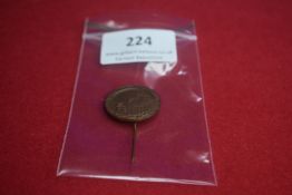 Bronze stickpin commemorating an architectural landmark, dated 1933. The front depicts a domed