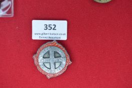 Sonnenwend 1936 Badge – A circular badge with central cross motif, red enamel flame surround,