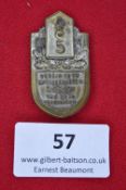 A German Veterans’ Commemorative Badge, brass shield-form issue for Verein ehem. Artilleristen
