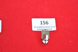 A German Third Reich political eagle and shield badge, die-struck example with enamel shield below