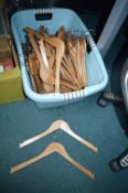Laundry Basket Containing Wooden Coat Hangers