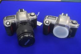 Two Nikon F65 35mm Cameras - 1 with Nikon AF Nikkor 28 - 80mm 1:3.3-5.6 Lens