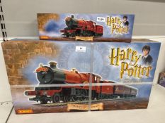 Harry Potter Hogwarts Express Electric Train set and a matching Howardâ€™s Express Train By Hornby