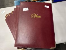 A quantity of red leather effect menu covers