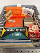 A basket of vintage picture slides and slide viewers