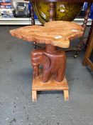 Wooden carved table featuring an elephant