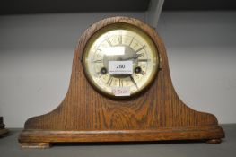 1930's oak cased mantel clock with brass face