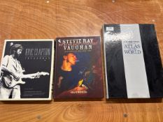 3x collectible books - times atlas of the world, Eric Clapton treasures and Stevie Ray Vaughan