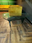 Glass topped black framed coffee table