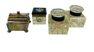 A collection of four desktop inkwells to include a silver plated Georgian example
