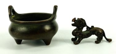 A patinated bronze tripod censer with twin loop handles and an inset four character seal mark