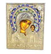 A Russian Icon with Cyrillic enamelling and a decorative white metal oklad