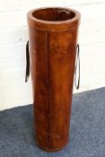 A contemporary stitched tan leather cylindrical stick stand with side handles