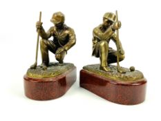 A pair of antique style bookends in the form of bronze golfers on porcelain bases