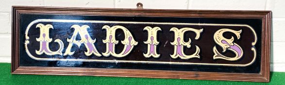 A decorative contemporary framed glass Ladies sign