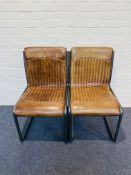 A pair of attractive contemporary stitched tan leather cantilever side chairs