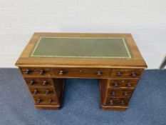 A small Victorian mahogany pedestal desk of nine drawers