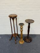 Three items to include two circular jardiniere stands and a tall hardwood candle stand
