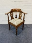 An early 19th century mahogany corner chair