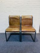 A pair of attractive contemporary stitched tan leather cantilever side chairs
