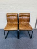 A pair of attractive contemporary stitched tan leather cantilever side chairs