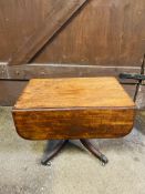 An early 19th century drop leaf pedestal pembroke table