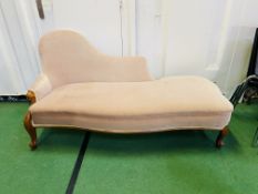 An upholstered serpentine fronted chaise longue