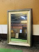 A large contemporary mirror with a bevelled plate glass