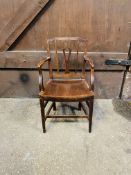 An early 19th century fruitwood elbow chair