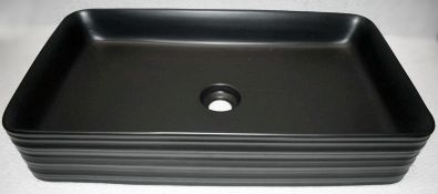 1 x Stylish Ceramic Basin in Black with a Selection of 6 x Waste Covers - Unused Boxed Stock