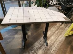 1 x Rectangular Dining Table Featuring a Black and White Tiled Top and Twin Pedestal Legs