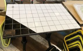 1 x Rectangular Dining Table Featuring a Black and White Tiled Top and Twin Pedestal Legs