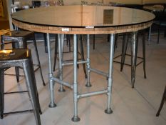 1 x Large Round Six Person Dining Table Feautring an Industrial Barrel Top with Glass Protector and