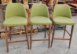 3 x Contemporary Bar Stools Featuring Wooden Legs with Footrests and Green Faux Leather Seats
