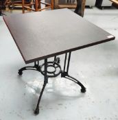 1 x Contemporary Restaurant Table Featuring a Dark Grained Wooden Top and an Ornate Pedestal