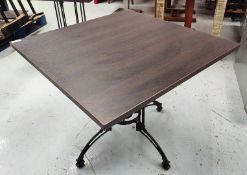 1 x Contemporary Restaurant Table Featuring a Dark Grained Wooden Top and an Ornate Pedestal