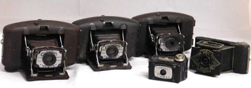 An Ensign Midget camera; three Coronet 'Vogue' camera's; and a Coronet Cameo camera, (5)