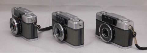 Three Olympus camera's: an Olympus-Pen Pen-EE, serial no. 985604; an Olympus-Pen Pen-EE, serial