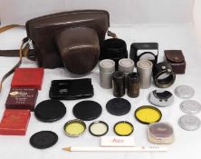 A quantity of assorted Leica accessories to include lens caps, lens hoods, film cannisters, filters,