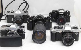 A quantity of camera's: to include an Olympus OM-10 with an Asahi Pentax Stereo Adapter; a Canon A-1